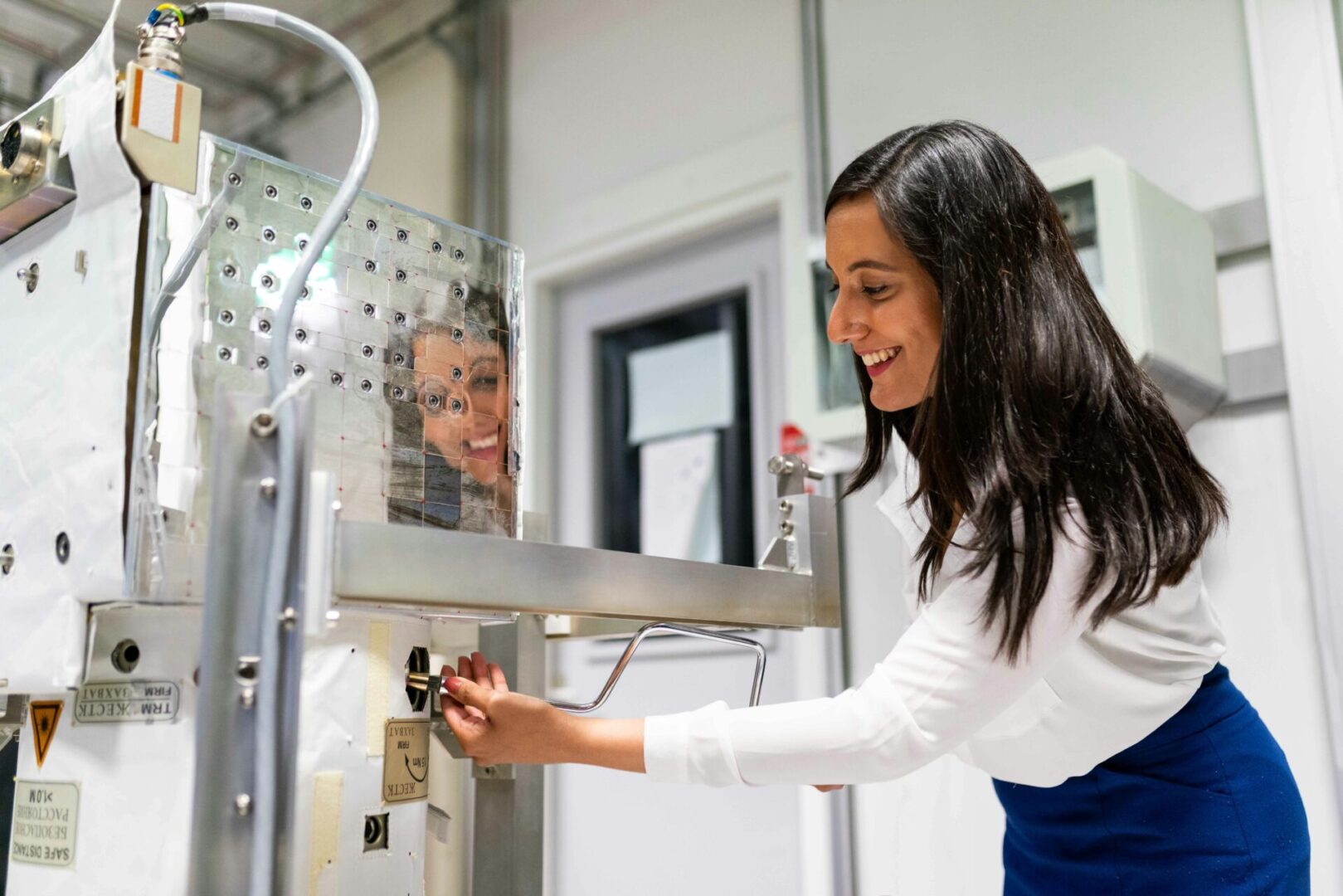 A woman smiling while holding onto a key